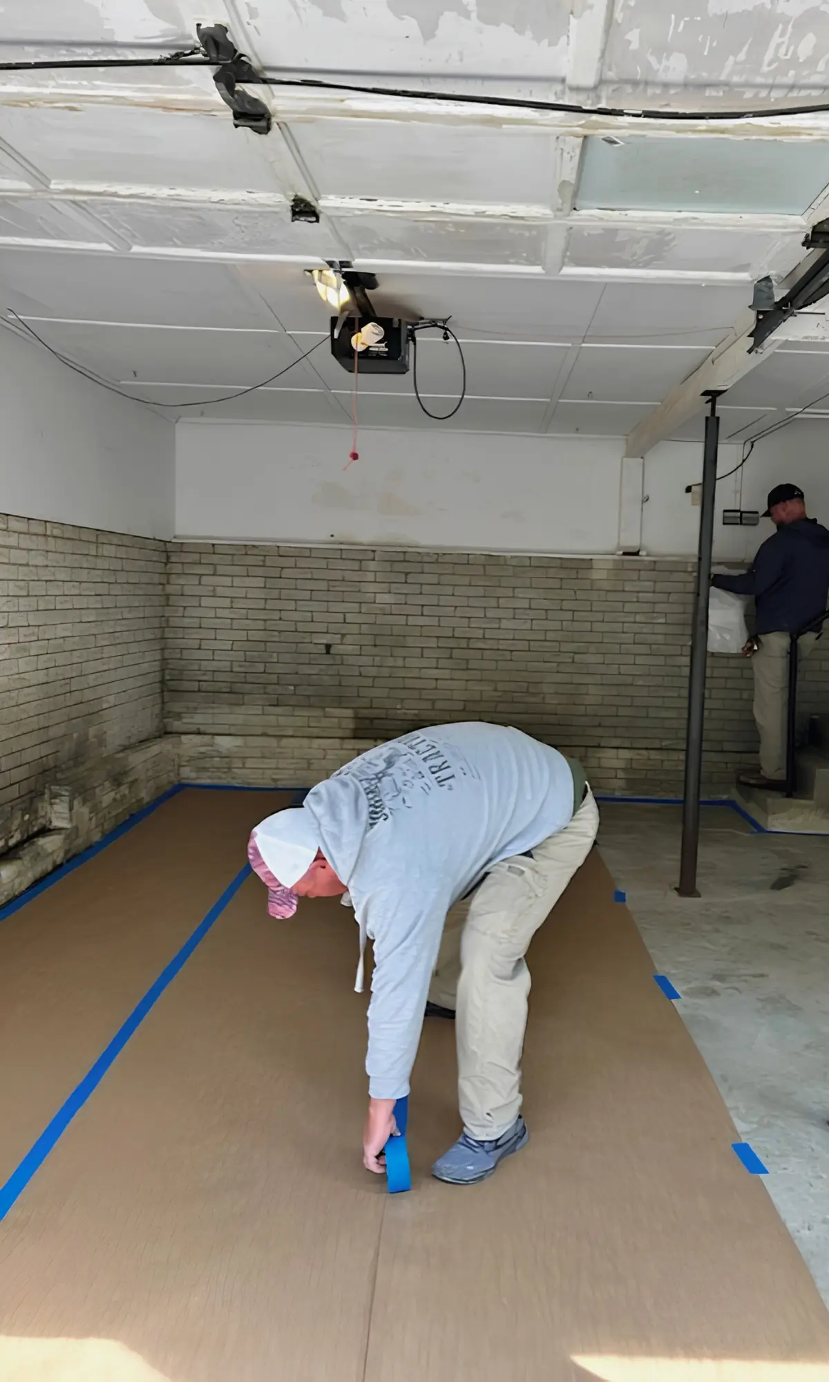 The Mold Patrol team laying down protective flooring during a mold remediation job