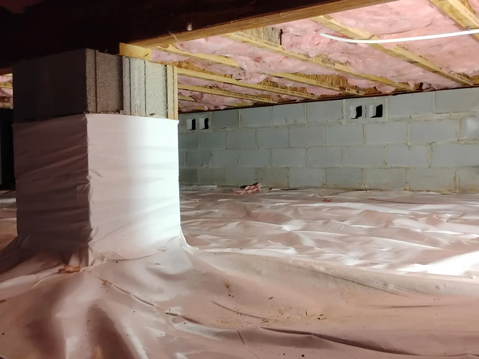 An installed crawlspace vapor barrier